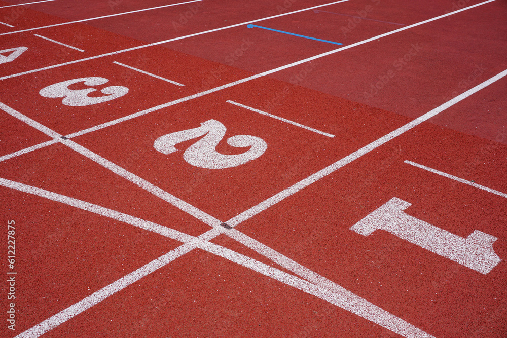 Athletics running track surface. sports and fitness background. Rubber material race track with lane and number markings 