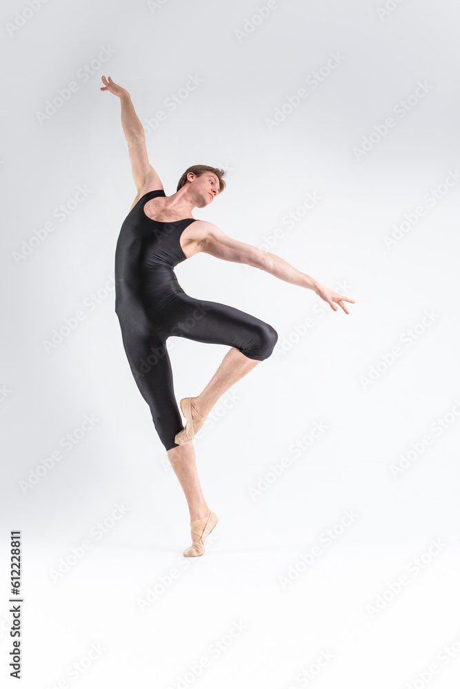 Obraz premium Modern Ballet Dancing. Contemporary Art Ballet of Young Caucasian Athletic Man in Black Suit Dancing