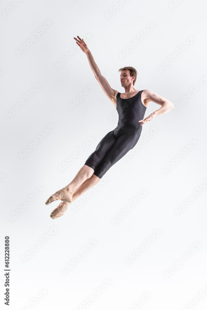 Professional Ballet Dancer Young Caucasian Athletic Man in Black Suit Posing Flying Dancing in Studio On White.