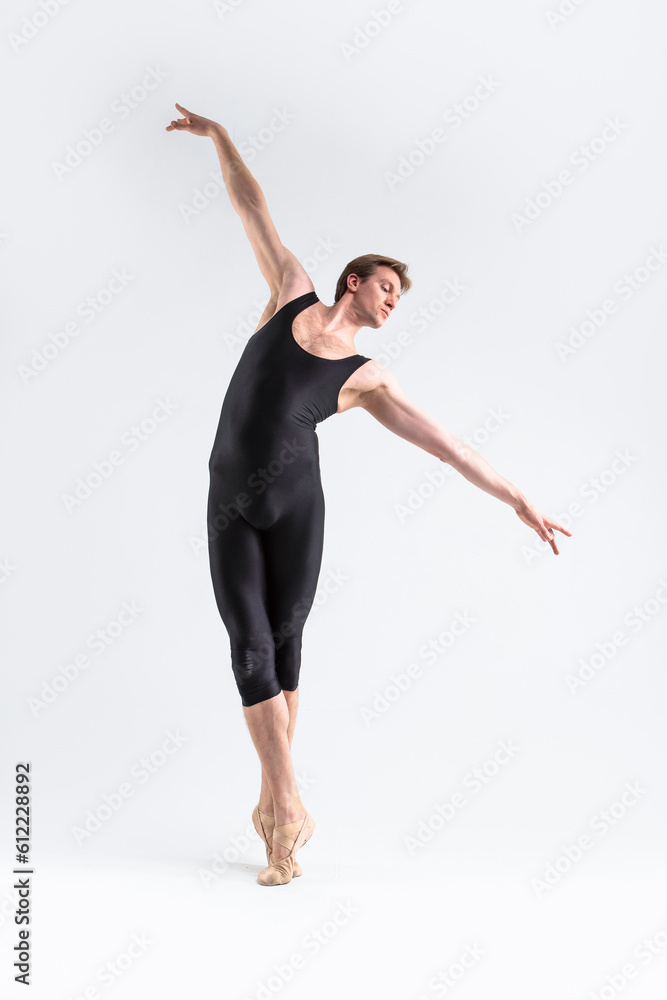 Ballet Dancer Young Athletic Man in Black Suit Posing in Stretching Dance Pose Studio On White.