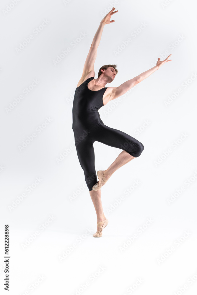 male Ballet Dancer Young Athletic Man in Black Suit Posing in Ballanced Stretching Dance Pose Studio On White.