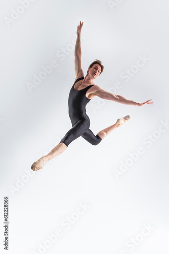 Modern Dance Concepts. Contemporary Art Ballet With Young Handsome Caucasian Dancing Athletic Man In Studio On White