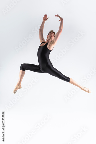 Caucasian Ballet Dancer Young Athletic Man in Black Suit Posing Dancing in Studio On White. © danmorgan12