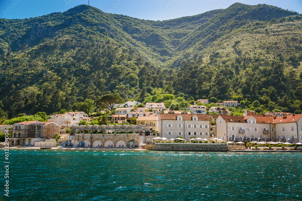 Cozy small village with old stone houses on the shore of Boka Kotor bay