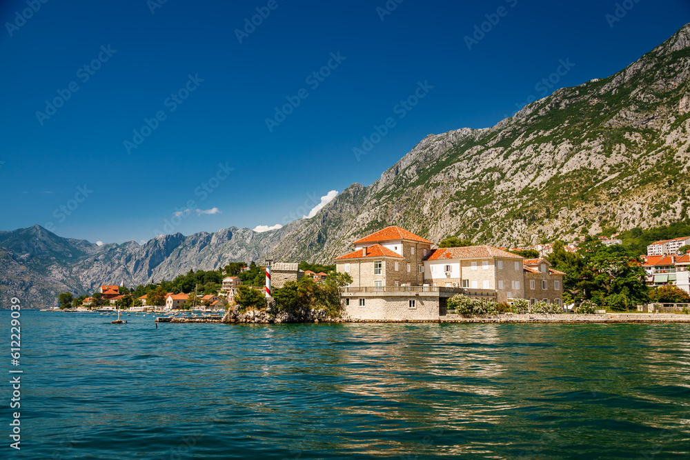 Scenic shore of the Bay of Kotor in Montenegro with old stone houses Scenic shore of the Bay of Kotor in Montenegro with old stone houses