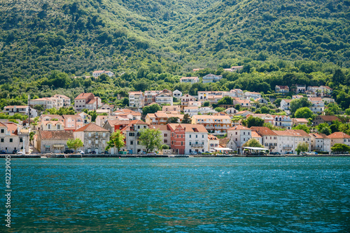 Cozy village with old stone houses on the seaside of the Bay of Kotor in Montenegro