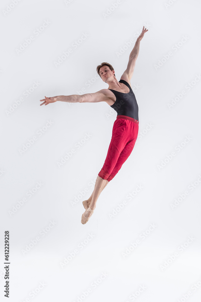 Modern Ballet Dancer. Contemporary Art Ballet With Young Flexible Athletic Man Posing in Flying Dance Pose in Studio Modern Ballet Dancer. Contemporary Art Ballet With Young Flexible Athletic Man Posing in Flying Dance Pose in Studio
