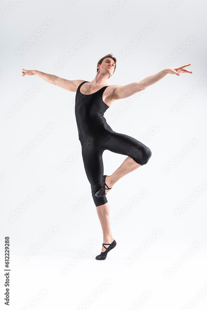 Male Ballet Dancer Flexible Athletic Man Posing in Black Tights in Ballanced Dance Pose With Hands Lifted