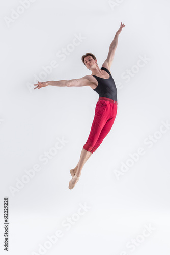 Modern Ballet Dancer. Contemporary Art Ballet With Young Flexible Athletic Man Posing in Flying Dance Pose in Studio