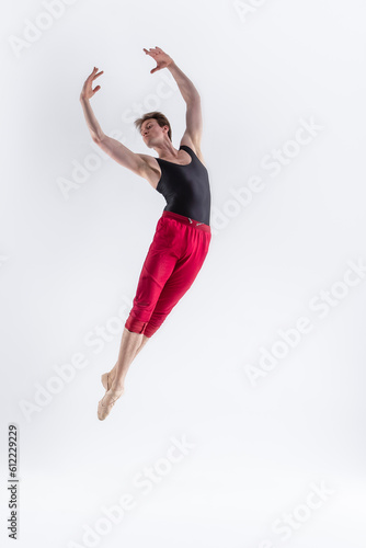 Male Flying Dancer. Contemporary Art Ballet With Young Flexible Athletic Man Posing in Flying Dance Pose With Hands Connected