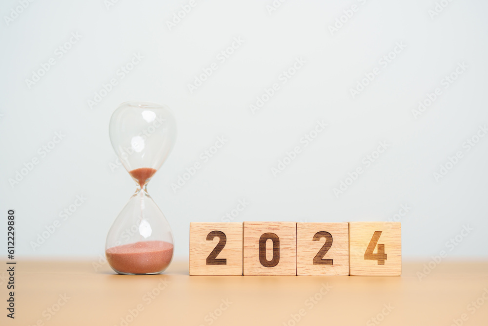 2024 text with hourglass on table. Resolution, time, plan, goal