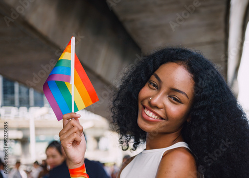 A young black woman showing symbols of homosexuality in pride parade.