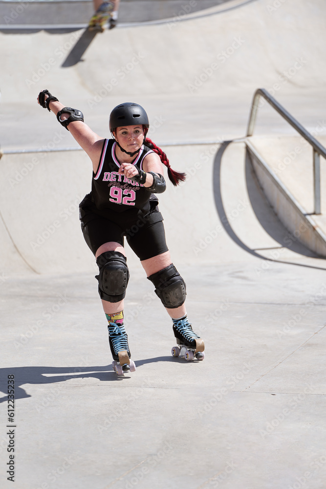 Young Woman Skating with Style and Confidence in a Skatepark, Wearing Protective Gear