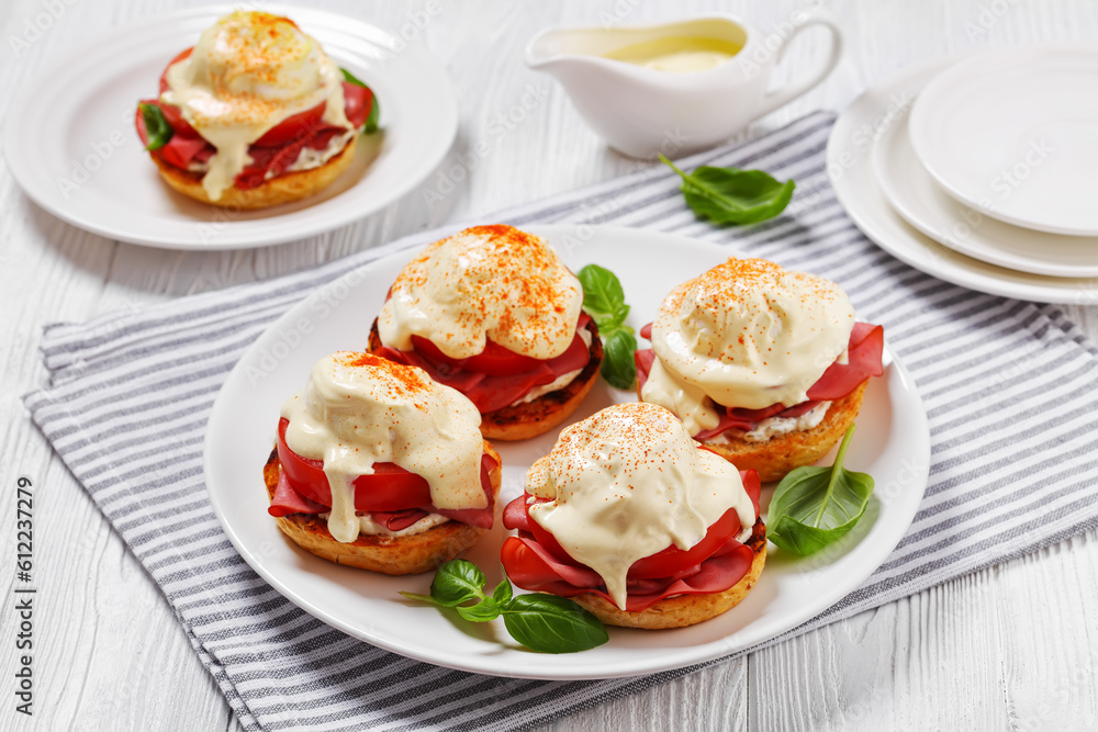 Eggs Benedict on white plate, top view Eggs Benedict on white plate, top view