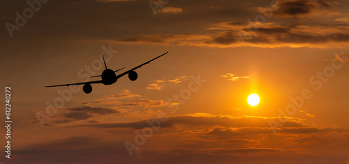 Passenger plane on the background of the sunset sky