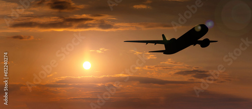 Passenger plane in the sky at sunset