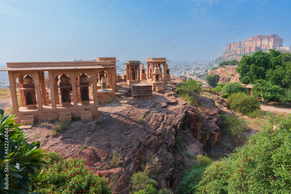 Beautiful decorated garden of Jaswant Thada cenotaph, Jodhpur, Rajasthan, India. Distant view of Mehrangarh fort. Garden has carved gazebos, a tiered garden, and a small lake with nice view.