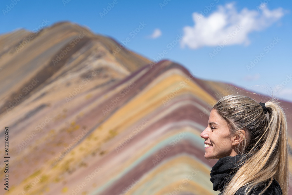 Fototapeta premium Blonde woman in landscape Rainbow Mountain or Montana Siete Colores, Cuzco, Peru