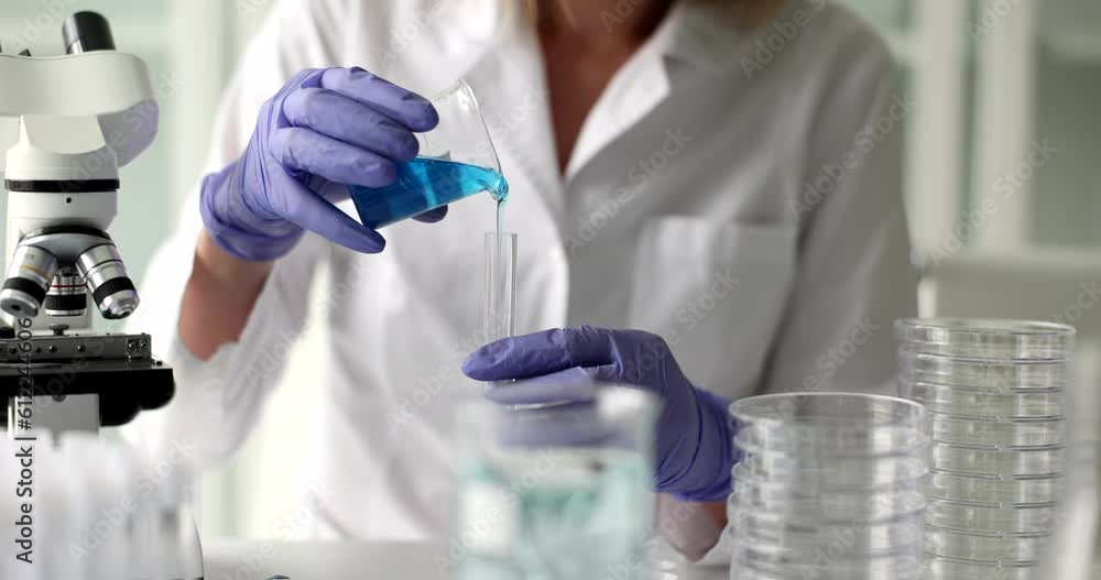 Medical or scientific laboratory researcher doing tests with blue liquid. Toxicological screening methods and poisonous technical liquids