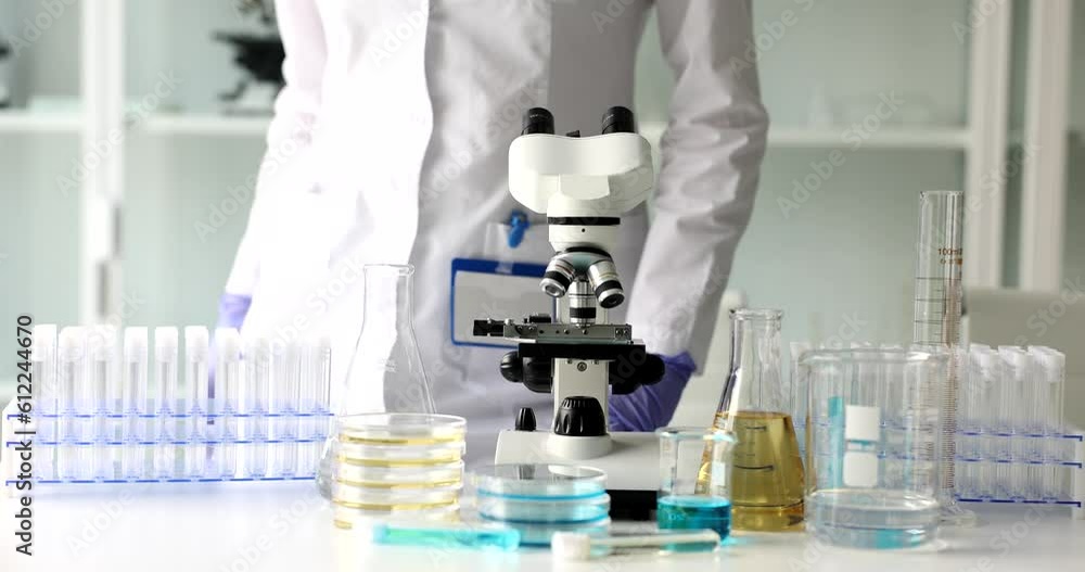 Scientist leaves after day work in laboratory. Completion of laboratory studies Scientist leaves after day work in laboratory. Completion of laboratory studies