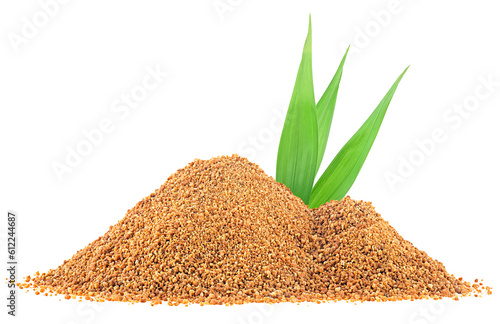 Pile of coconut palm sugar and green palm leaves isolated on a white background. Coco sap sugar or coconut blossom.