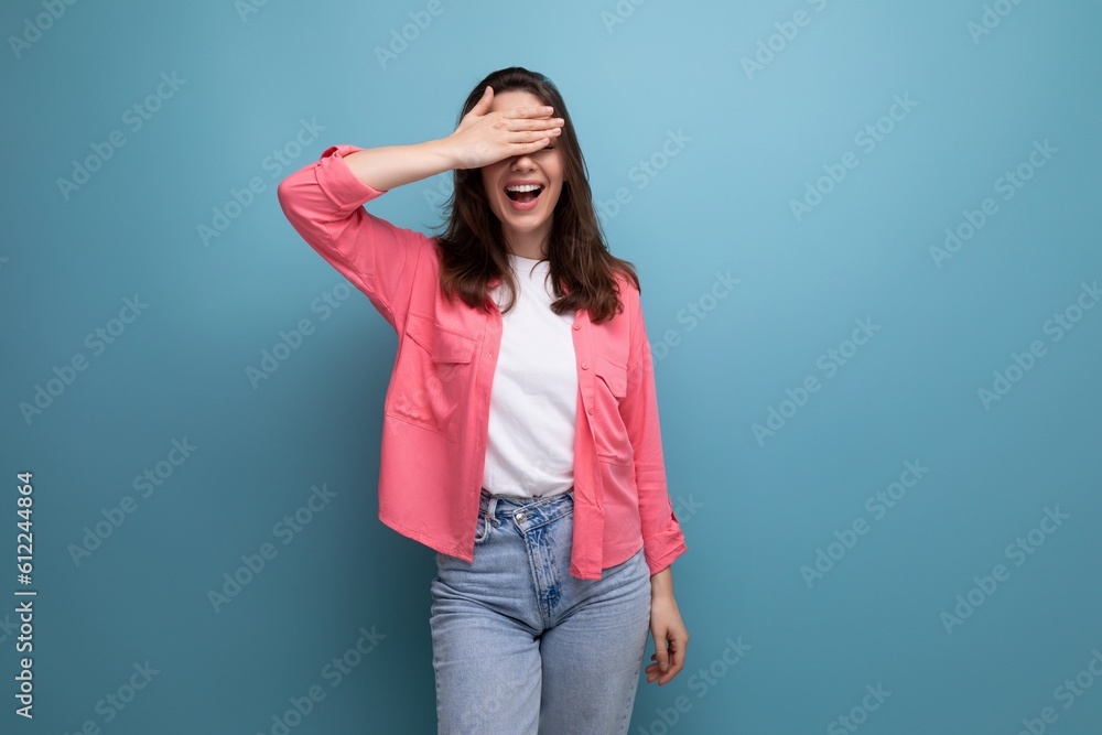 brunette young woman with shoulder-length hair in a pink shirt closed her eyes brunette young woman with shoulder-length hair in a pink shirt closed her eyes