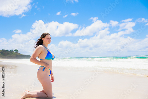 大海原の前で膝立ちするオーストラリア人少女