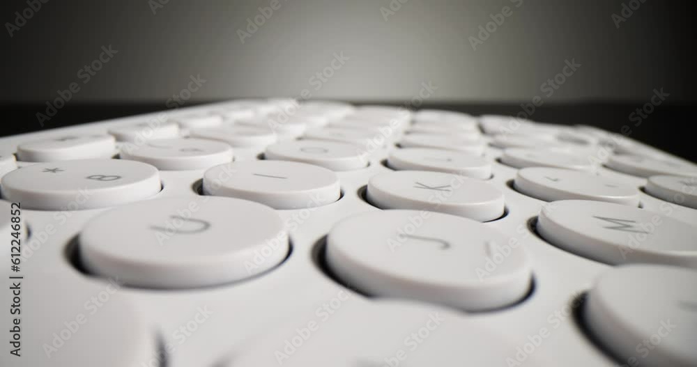 Modern white computer keyboard on a black background. Profession of IT specialists Modern white computer keyboard on a black background. Profession of IT specialists