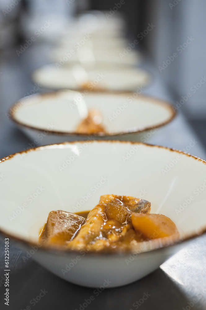 View of a serving of fish dishes in a restaurant kitchen.