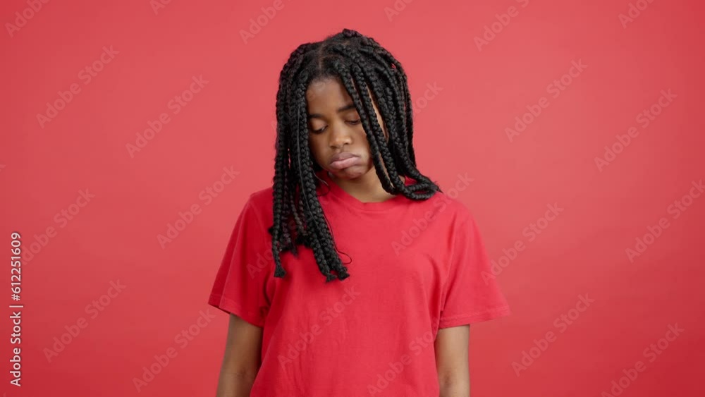Sad african woman standing and looking at the camera Sad african woman standing and looking at the camera