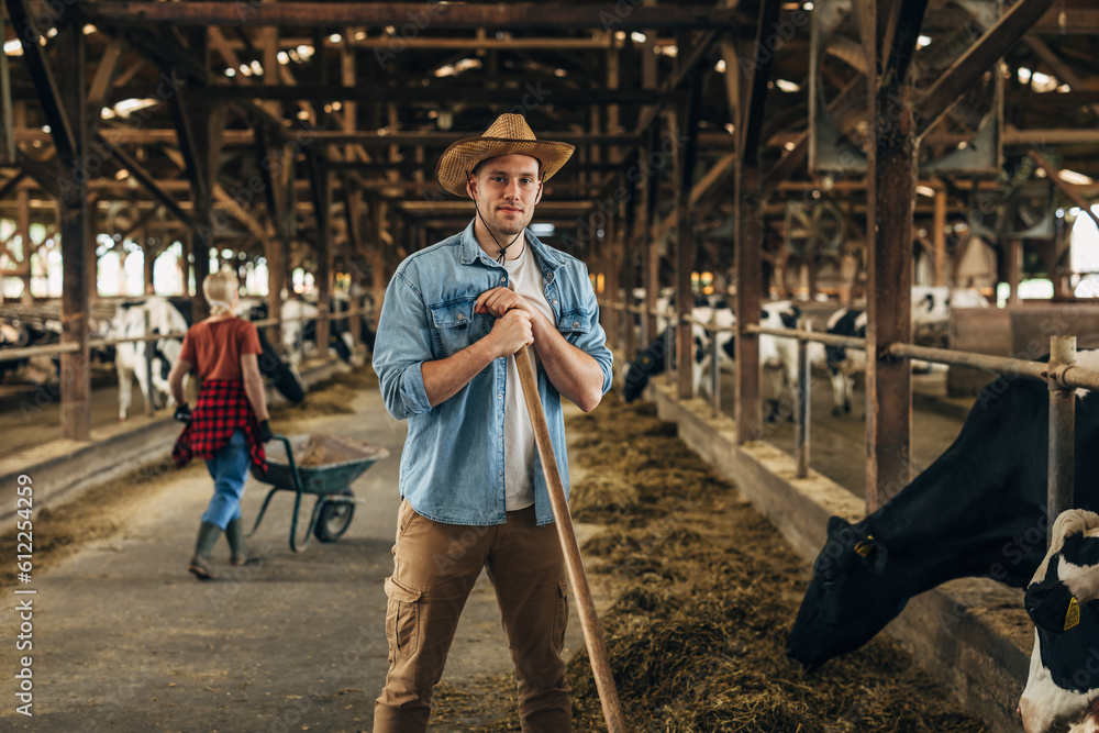 Caucasian farmer is working in a stable and looking at the camera. Caucasian farmer is working in a stable and looking at the camera.