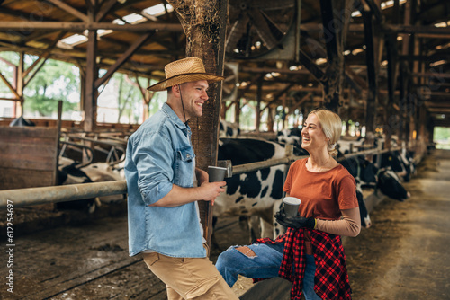 A man and a woman have a nice time taking in a barn.