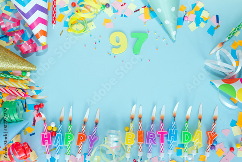 Top view card happy birthday with number 97. Copy space. Postcard holiday anniversary. Happy birthday multicolored background for mensto text, with a numeral with pretty decorations in pastel colors.