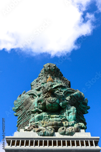 A portrait of Garuda Wisnu Kencana statue  an iconic cultural landmark in Bali  at the GWK Cultural Park with blue sky as background