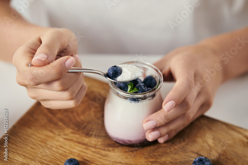 cropped shot woman table top yogurt