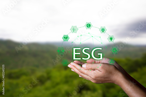 .Net zero concept. Hand holding bulb with ESG icon. It is surrounded by a clean energy icon. Net zero 2050. Carbon gas affects global warming. Concept with innovation inspiration from big data.