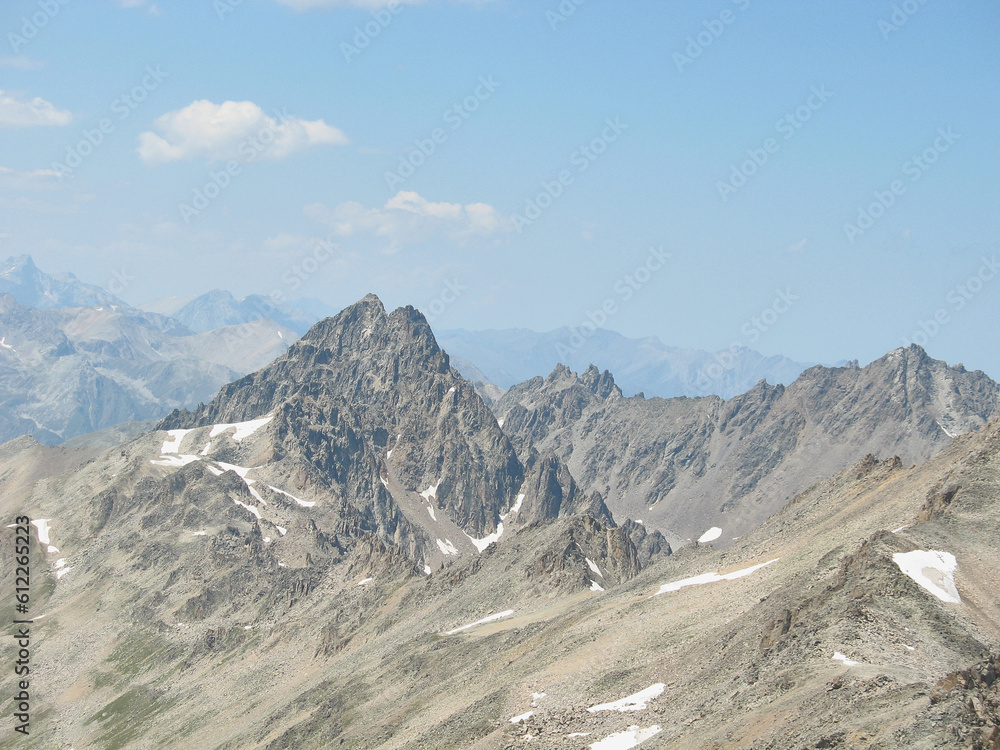 Aerial panoramic view of the Main Caucasus Mountain Ridge from Mount Elbrus, the highest summit in Europe, glacier Seven, incredible blue sky background, impressive nature landscape in North Caucasus