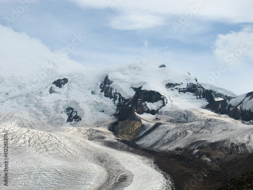 Aerial panoramic view of the Main Caucasus Mountain Ridge from Mount Elbrus, the highest summit in Europe, glacier Seven, incredible blue sky background, impressive nature landscape in North Caucasus