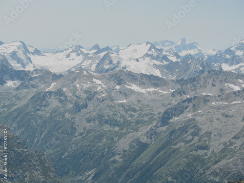 Aerial panoramic view of the Main Caucasus Mountain Ridge from Mount Elbrus, the highest summit in Europe, glacier Seven, incredible blue sky background, impressive nature landscape in North Caucasus