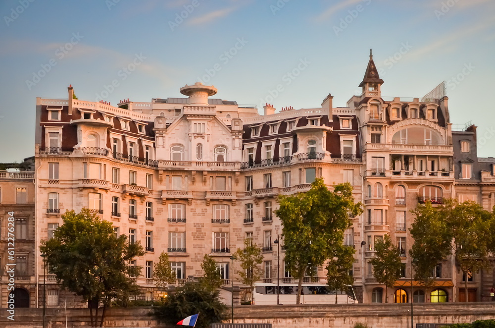 Exterior view of an aged gray residential building located in Paris.
