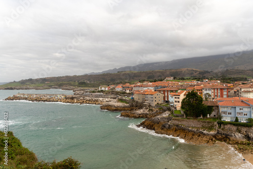 Panoramic and aerial view of the coast of Llanes and the Sablón beach with its golden sand on a cloudy day in the province of Asturias.
