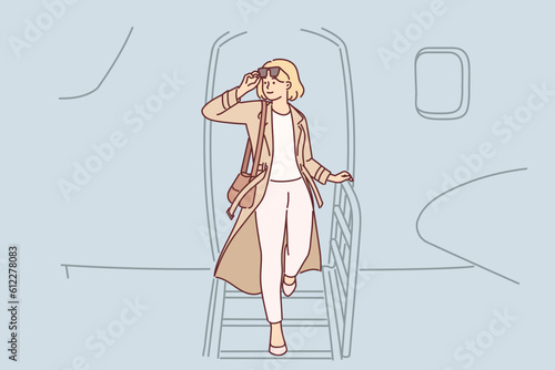 Woman gets off airplane, having arrived on business trip on private flight to conclude contract