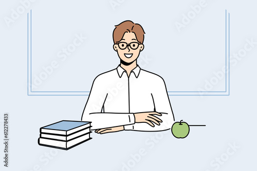 Male student in glasses sit at desk with books. Smiling man with textbooks on table in university or college. Education and wisdom. Vector illustration. 