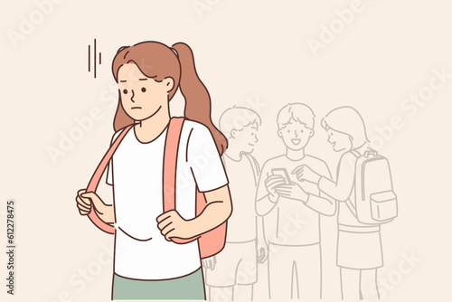 Lonely schoolgirl is sad because of lack of friends and being ignored by classmates from school