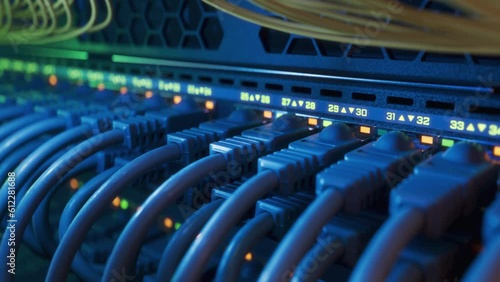 Close-up Shot of Datacenter Network Switch full of Plugs and Connectors in Rack Cabinet. Internet Ports with Blinking Lights on Industrial Router. High Performance Network Equipment. photo