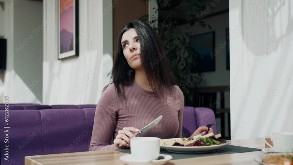 Woman having breakfast and drinking coffee in a beautiful restaurant Portrait Woman having breakfast and drinking coffee in a beautiful restaurant Portrait