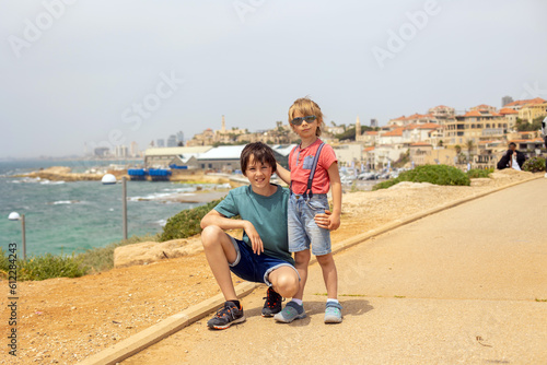 European tourist family with children, visiting Tel Aviv, Israel, enjoying day walk