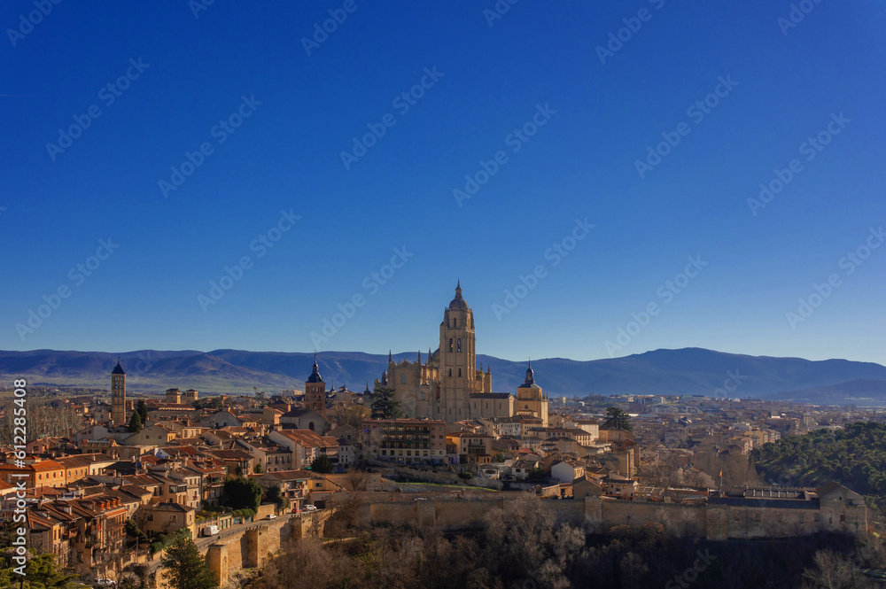 Cityscape of Segovia, Spain, with the mixture of medieval and Romanesque architecture and its majestic mountains in the background