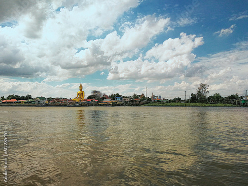 Big Buddha statue in a riverside temple photo