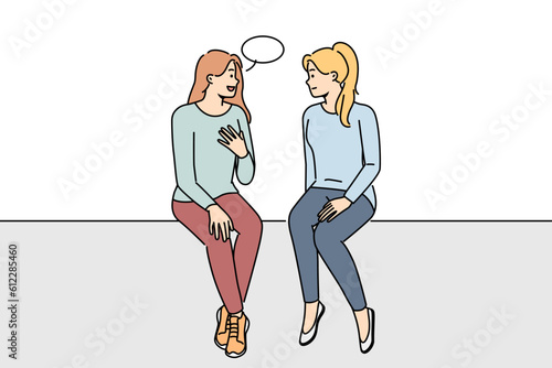 Happy girls sitting talking with speech bubble above head. Smiling women have conversation engaged in interesting discussion. Communication. Vector illustration. 